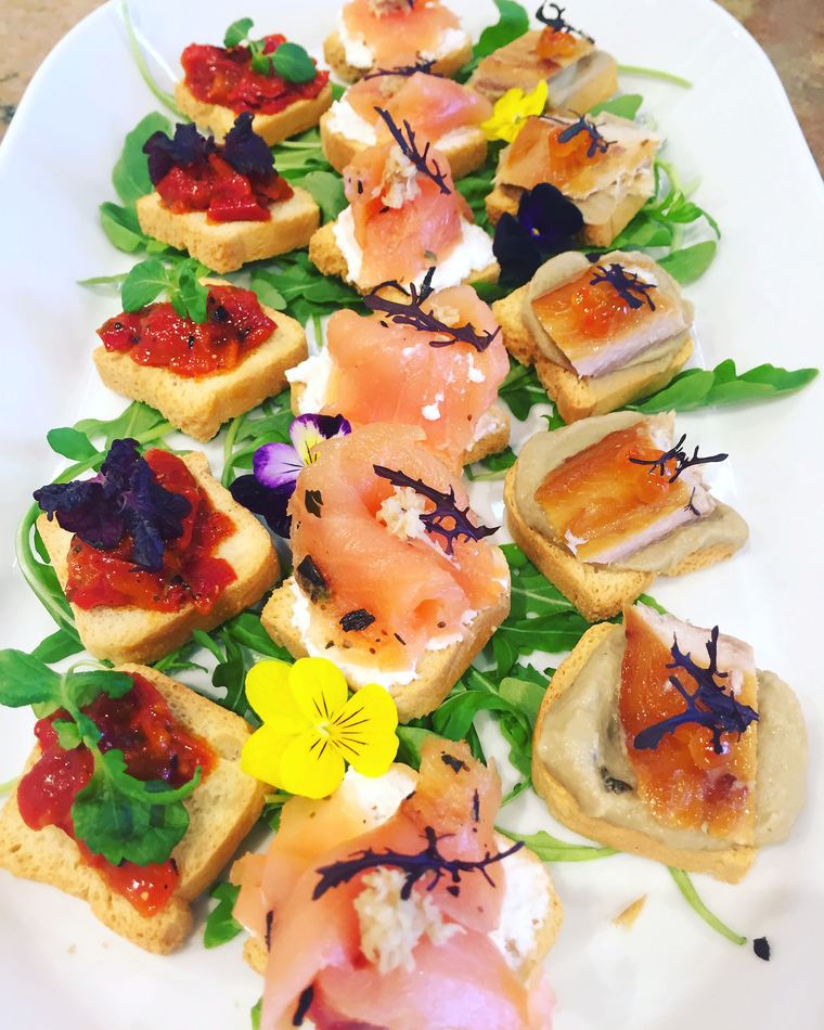 A canap&eacute; selection with smoked salmon and edible flowers