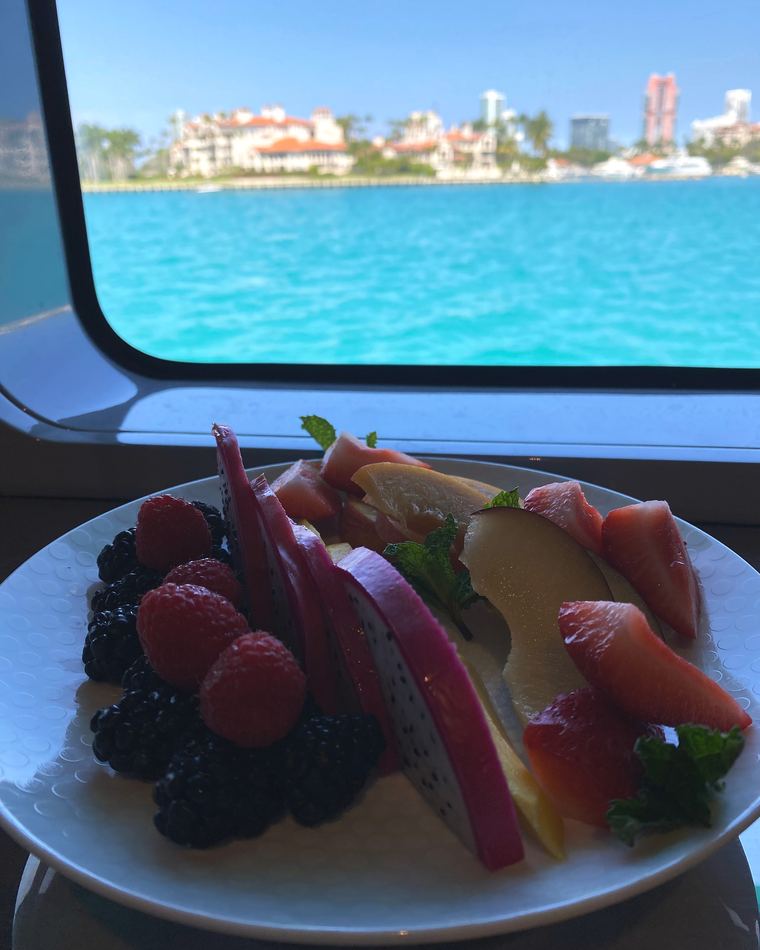 A fruit plate at the window with the sea beyond