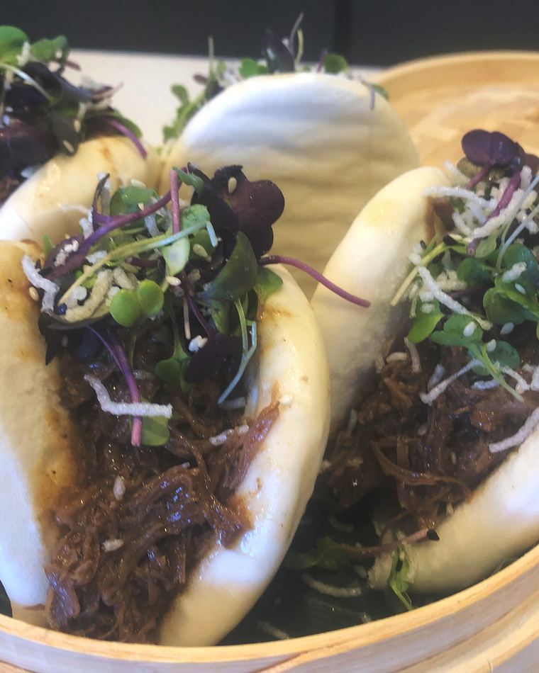 Bao buns with slow-cooked pork and micro herbs