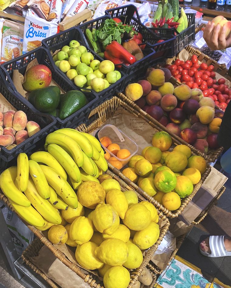 A market stall stacked with fruit and vegetables